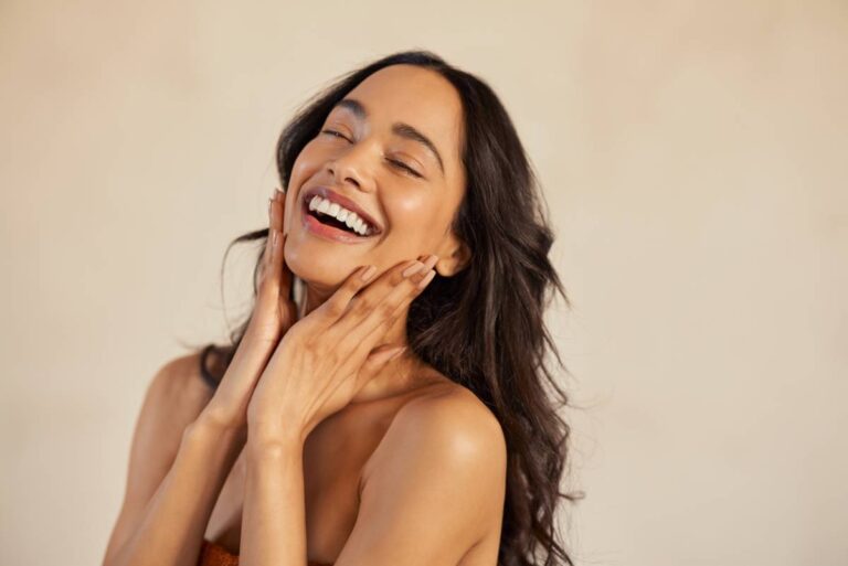 woman with radiant skin laughing showcasing skin care best practices results